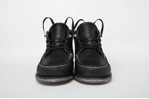 Best hand-sewn moccasins in black leather with visible white stitching, showcased front-facing on a white background.